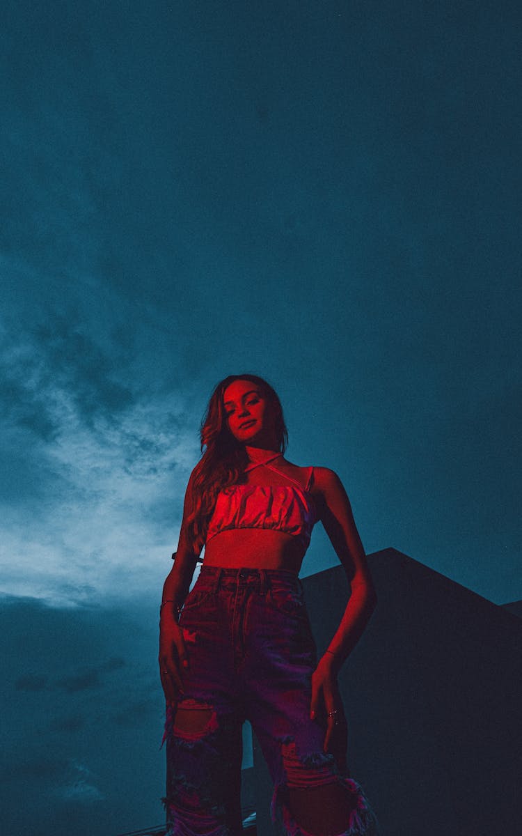 Woman Posing In Light At Night Sky