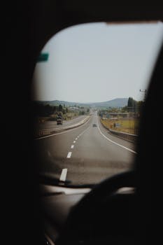 View of an open highway from inside a vehicle, depicting travel and adventure.