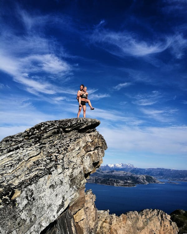 Landscape Photography of Two Persons on Cliff