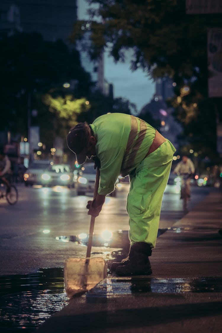 Man Cleaning City Street