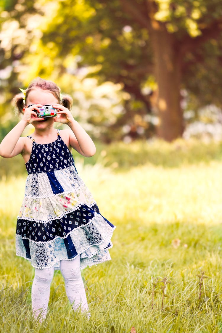 Photography Of Girl Taking Picture