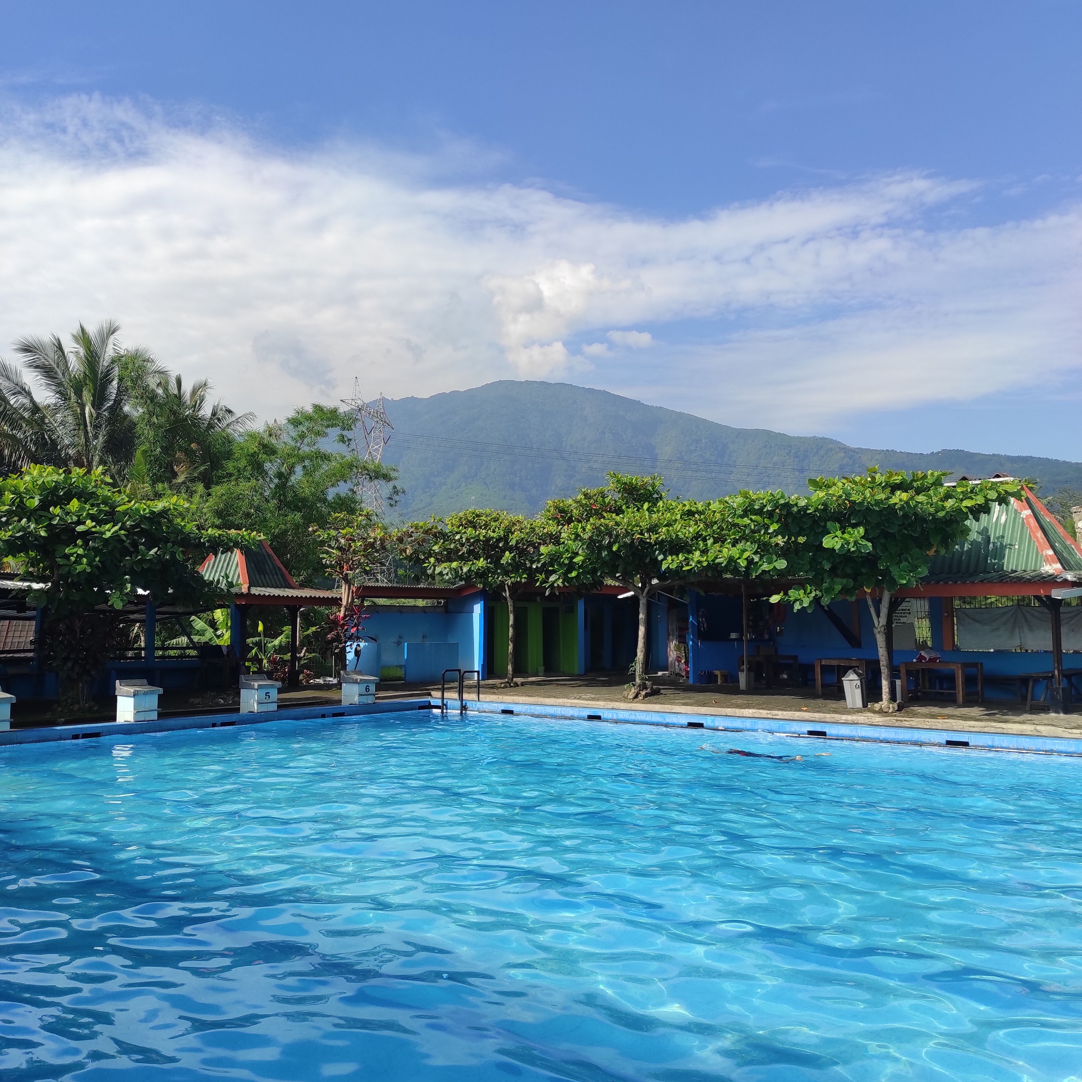 Scenic swimming pool in Central Java with mountain view, ideal for travel and relaxation.