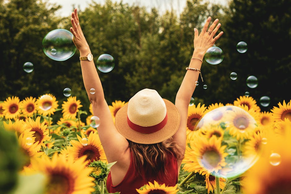 Photography of Woman Surrounded by Sunflowers