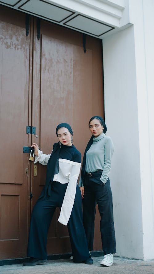 Two Women Standing by a Door