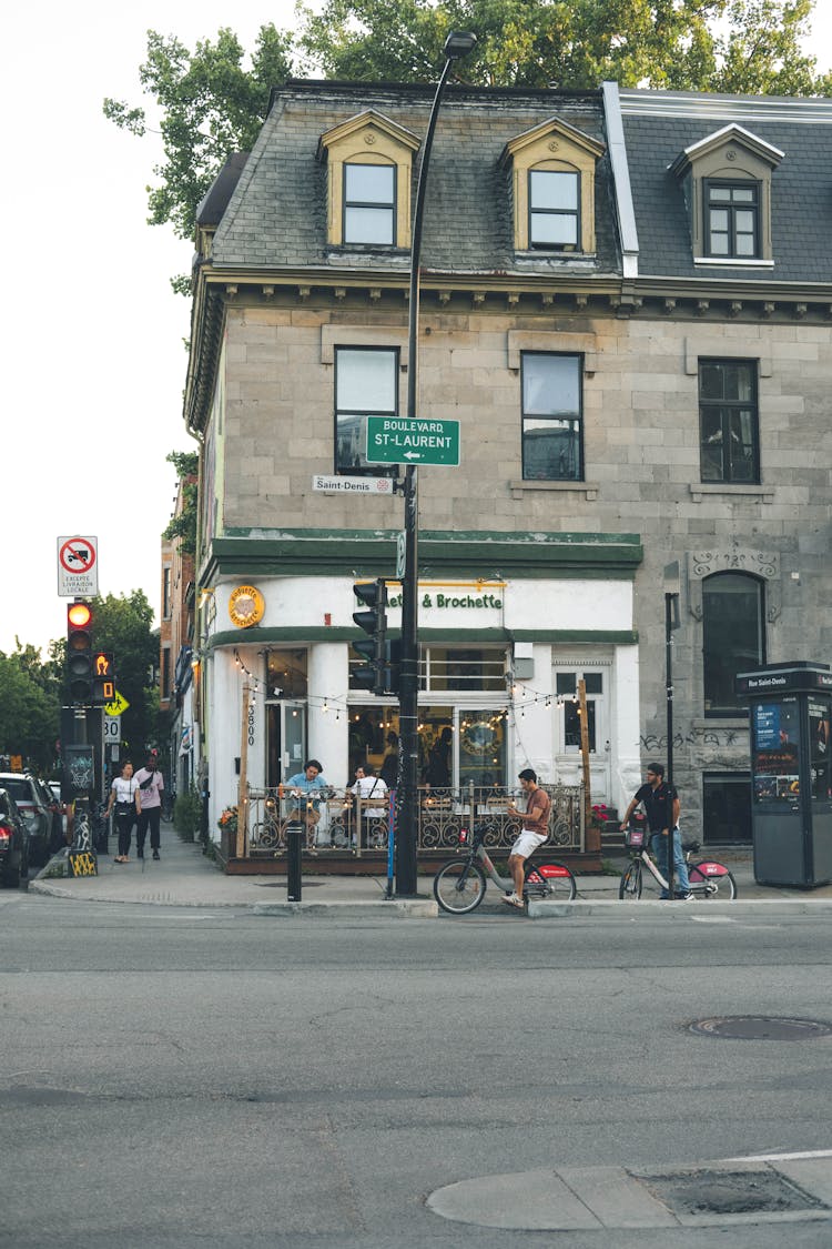 People At The Street Corner By A Restaurant In Montreal, Canada