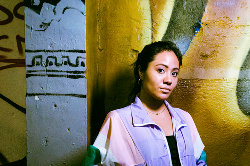 Free Colorful portrait of a woman in front of a graffiti wall, captured in Ciudad de México. Stock Photo