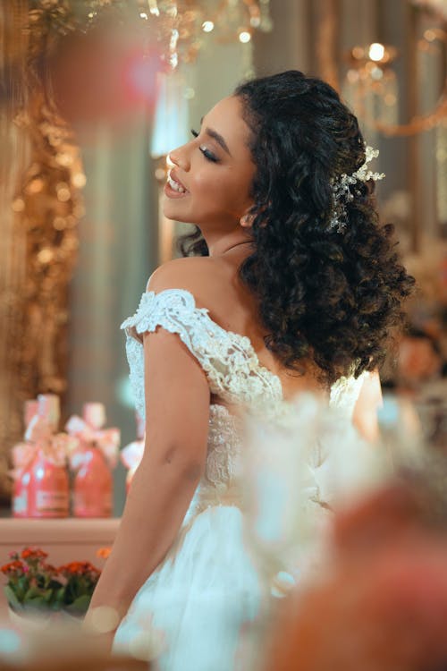 Smiling Quinceañera Posing in a White Gown