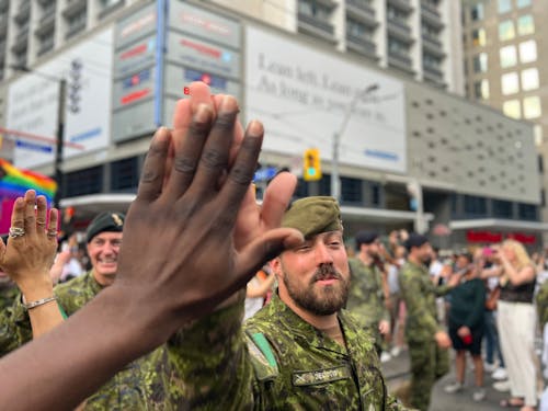 Man High Five with Military Man on City Street