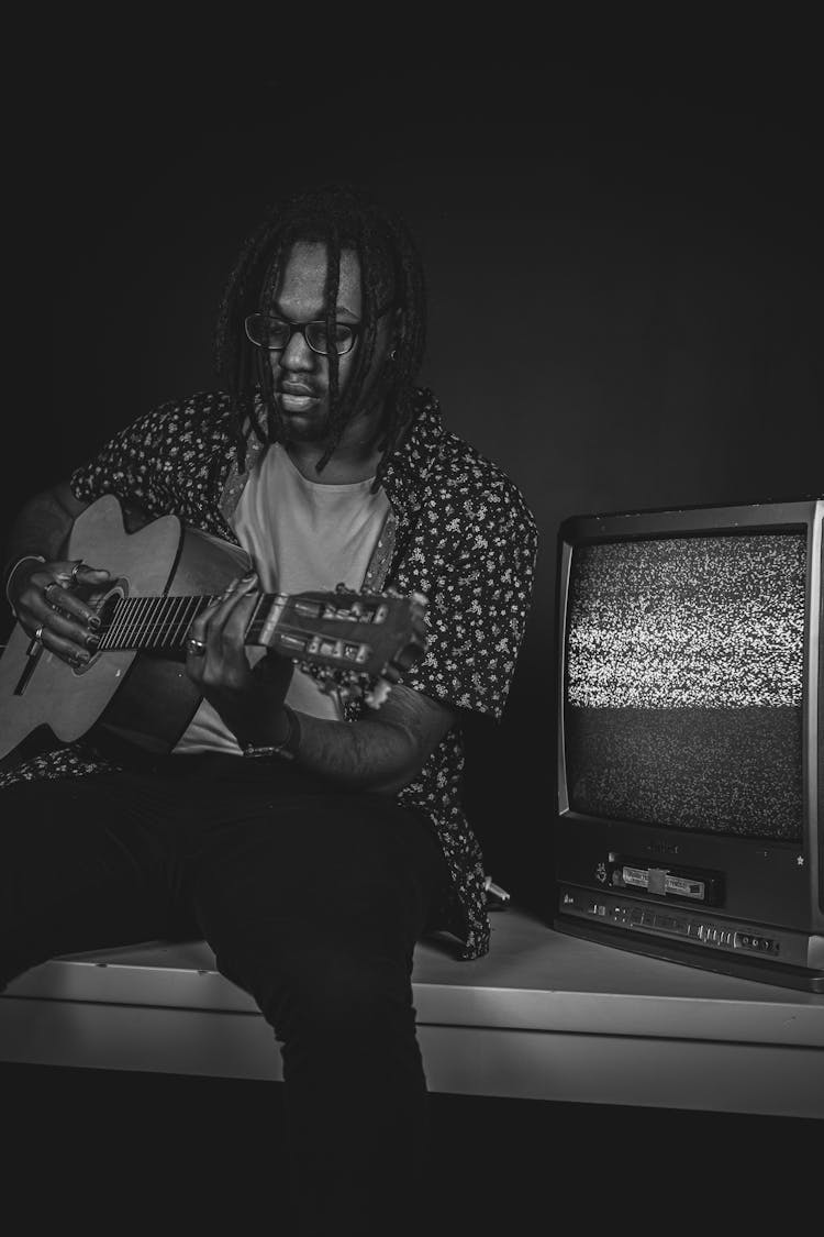 Young Man Playing The Guitar 