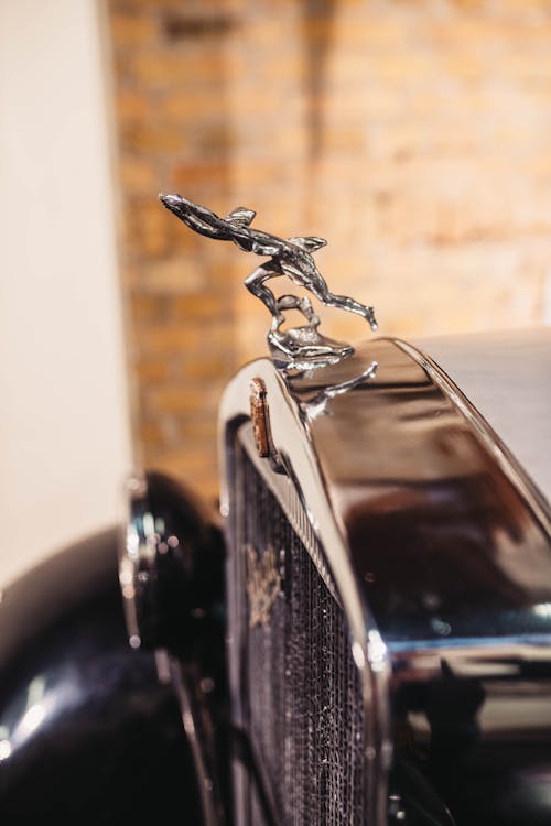 Shiny Figurine on Retro Car