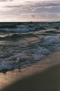 A tranquil beachfront scene with gentle waves and a calming sunset view for relaxation and nature appreciation.