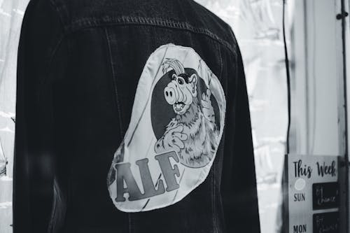 A Person A Denim jacket with an Alf Print in the Back