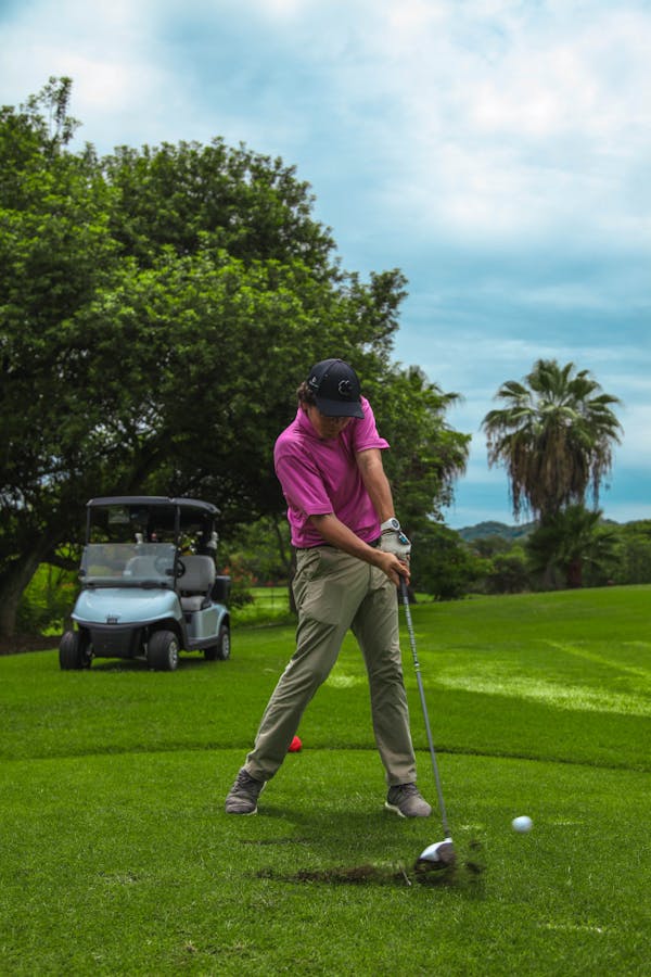 Man in Red Polo Shirt and Gray Pants Playing Golf