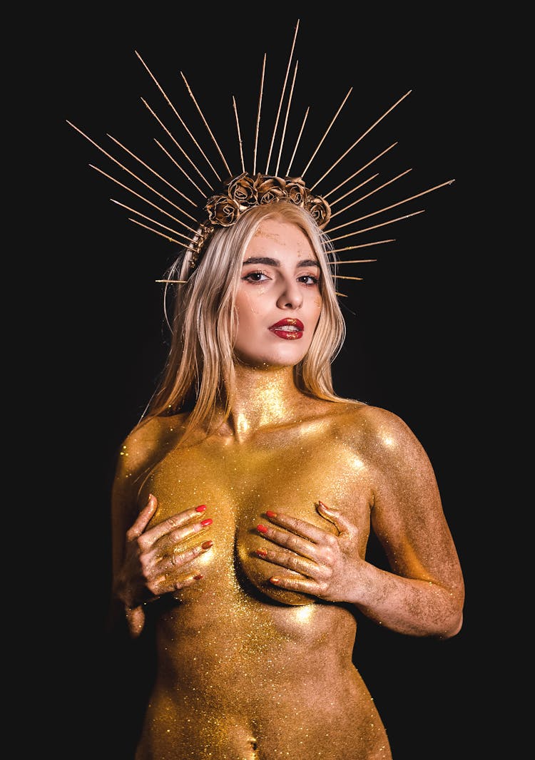 Woman Covered In Golden Glitter Wearing A Crown