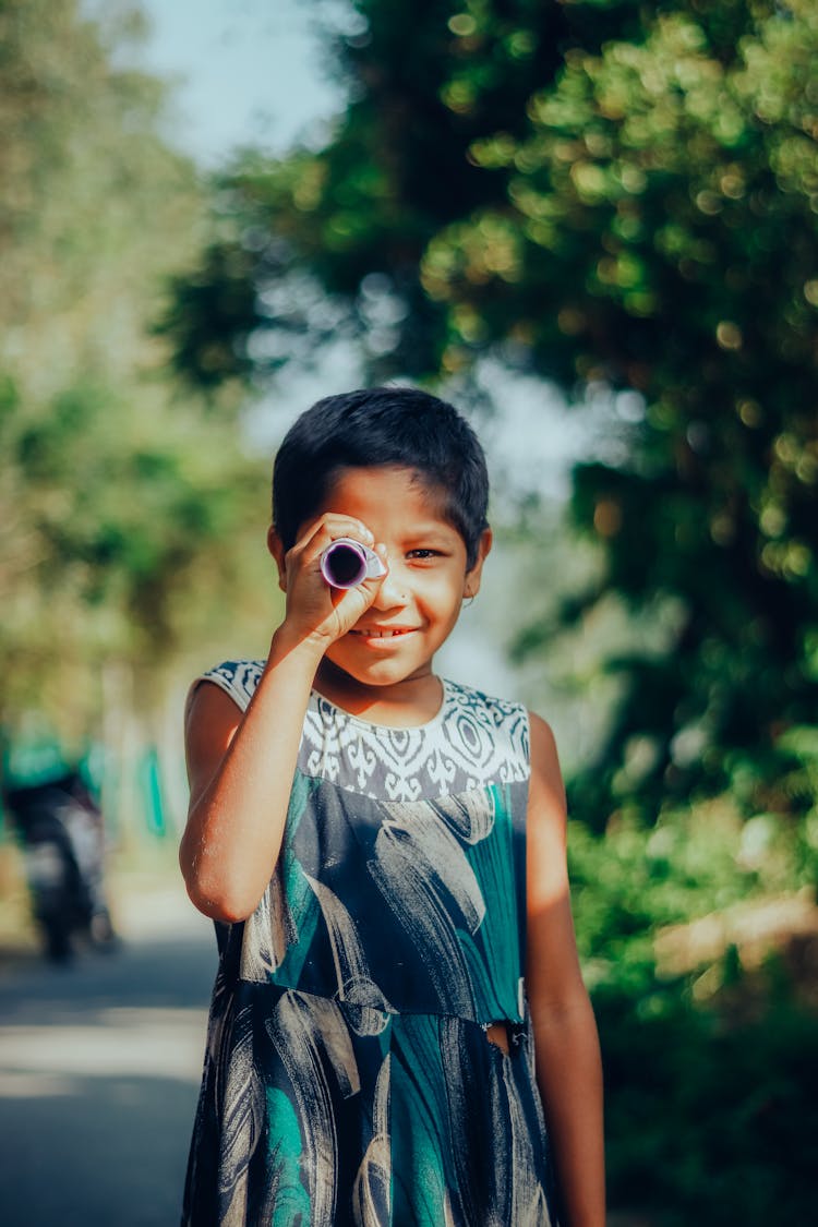 A Girl Looking Through A Paper Telescope