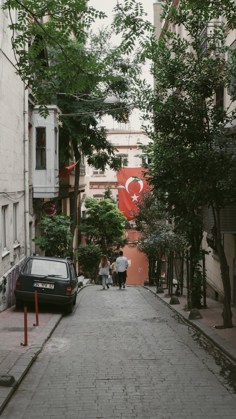 Back View Of People Walking On The Alleyway