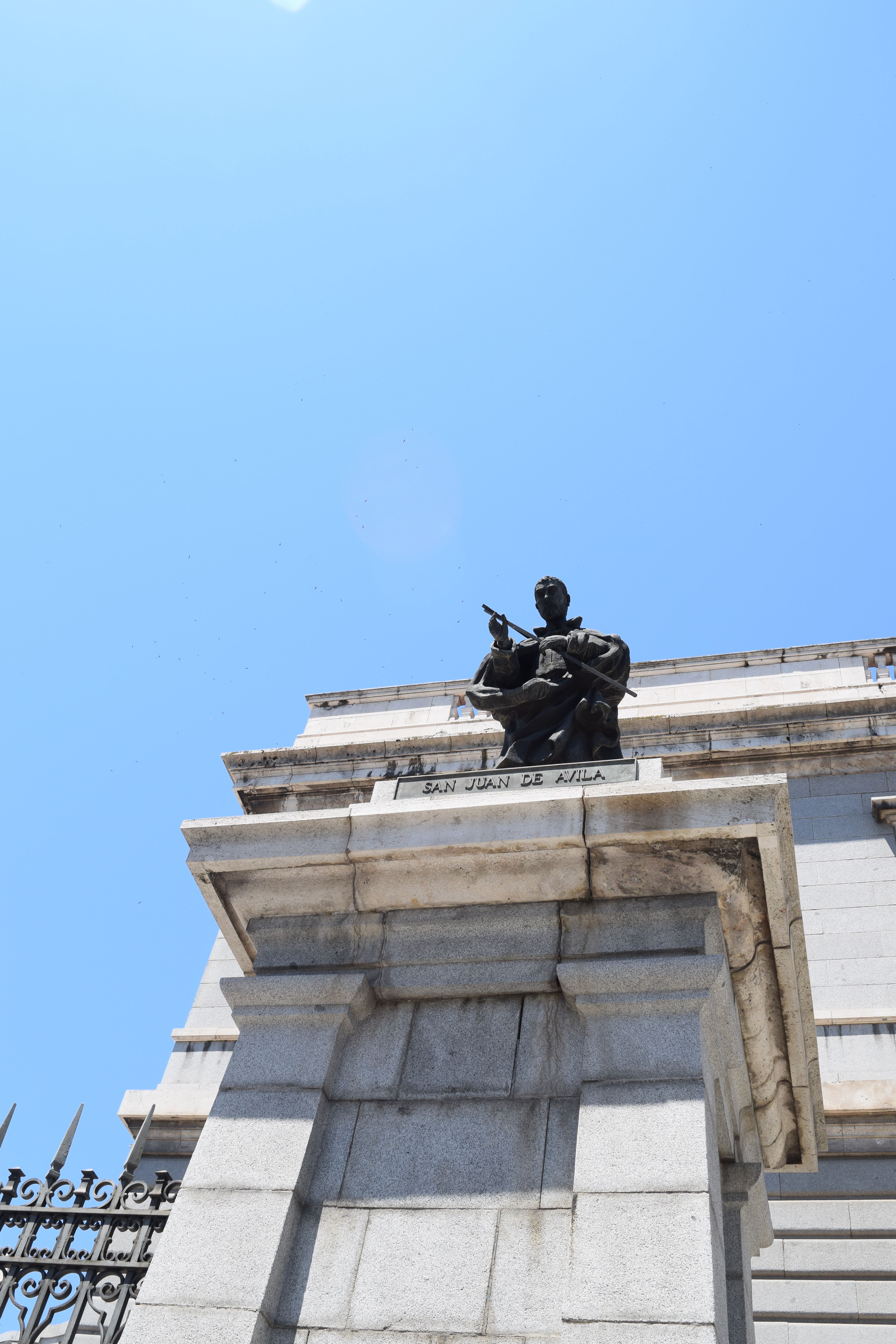 Low-angle shot of a San Juan de la Cruz monument in Madrid, sunny day.