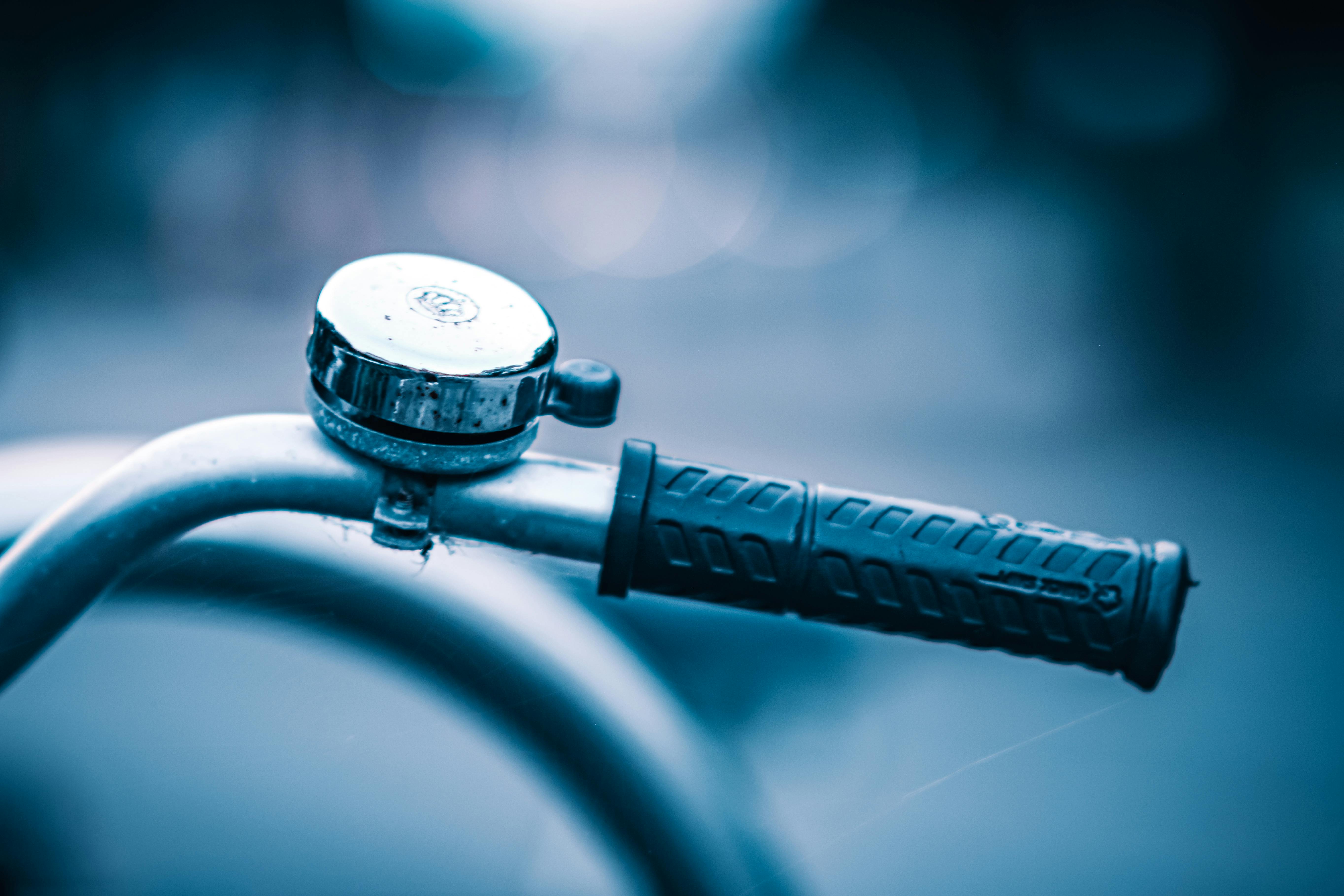 Close up Photo of a Silver Bicycle Bell and Bicycle Handlebar Grip