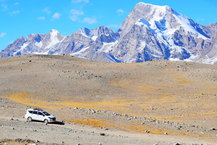 White Car On Road Near Snow Covered Mountain