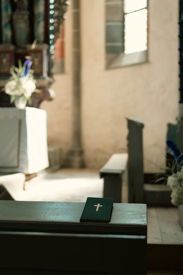 Bible Lying On Top Of A Church Pew