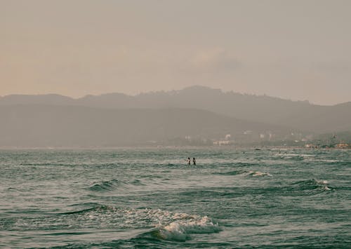Free Waves in a Sea by the Mountain Valley  Stock Photo