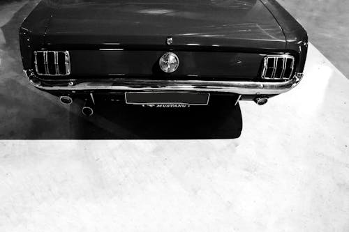Grayscale Photo of the Rear of a Ford Mustang