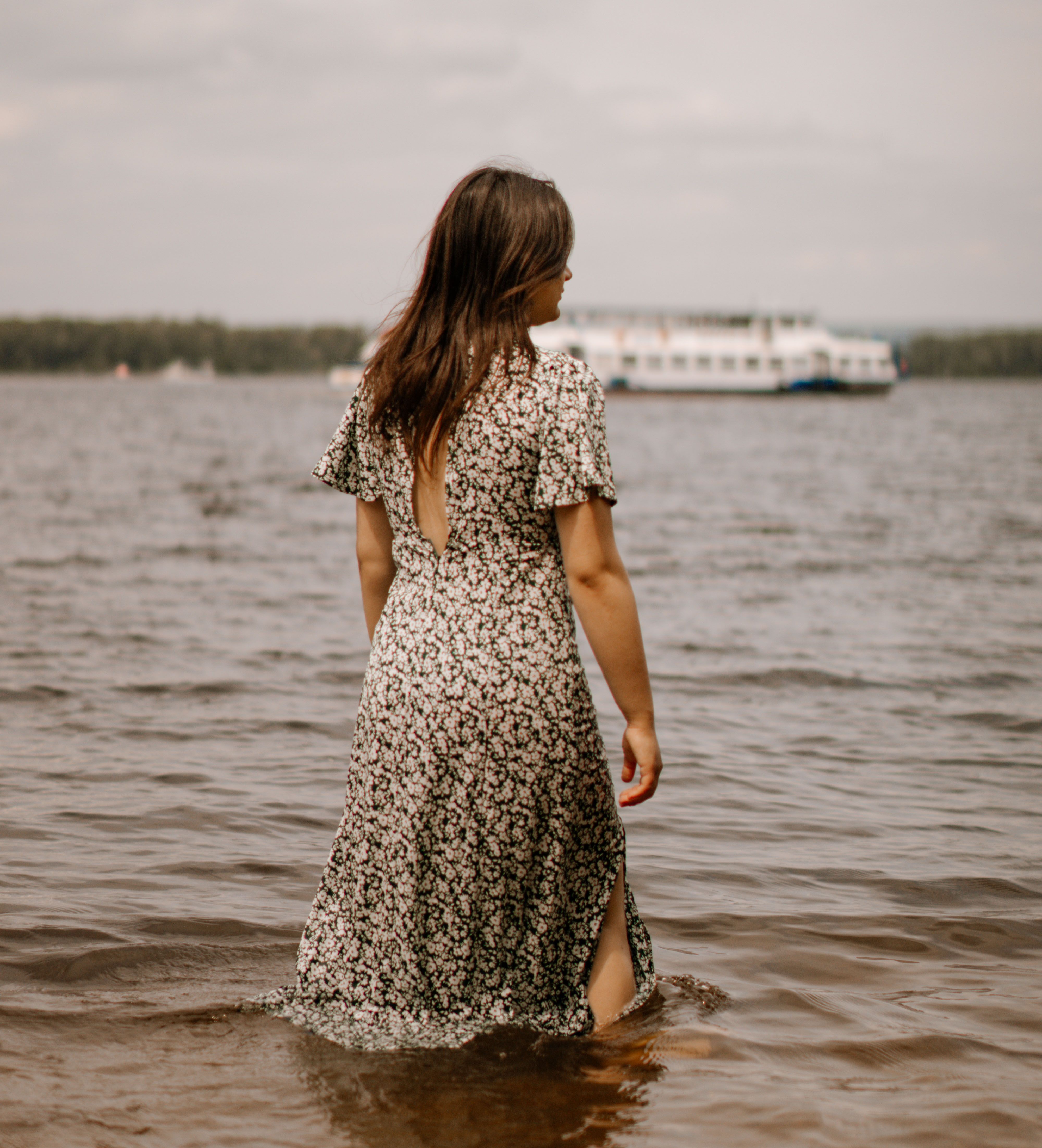 Back View of a Woman in Floral Dress Standing in the Water · Free Stock ...