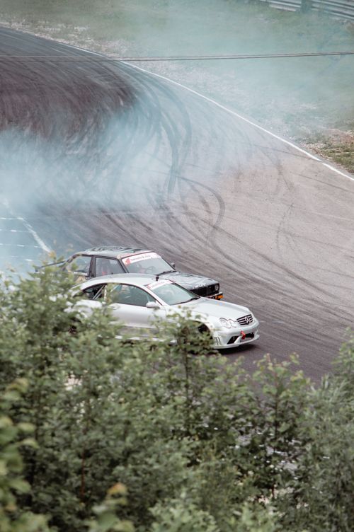 Free High-speed car drifting on a Lithuanian race track, showcasing skill and excitement. Stock Photo