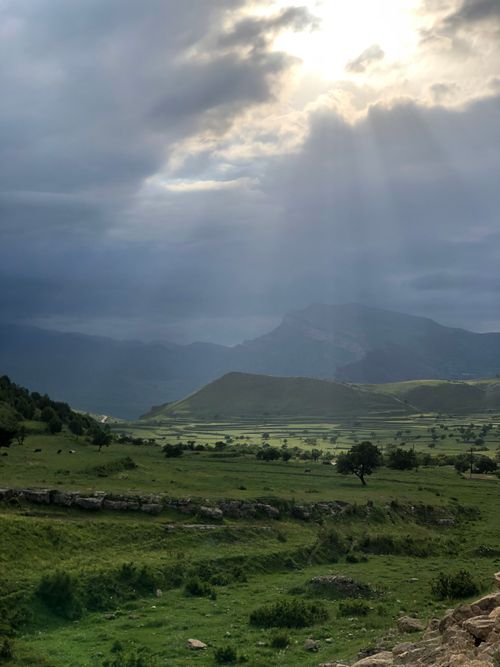 Free Sun rays breaking through clouds over scenic mountains in Dagestan, Russia. Stock Photo