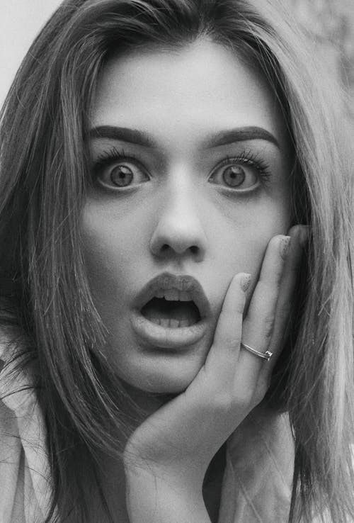 Grayscale Photo of Shocked Woman's Face