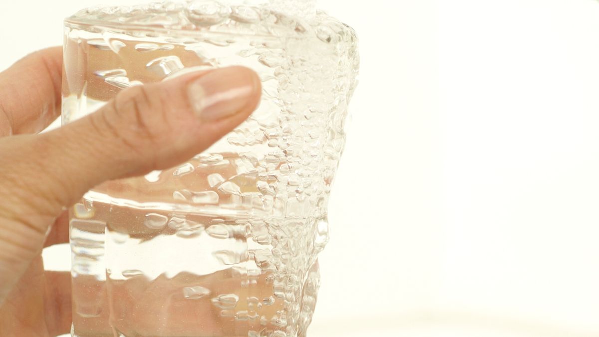 filtered water for home safety poured from a kitchen tap into a glass