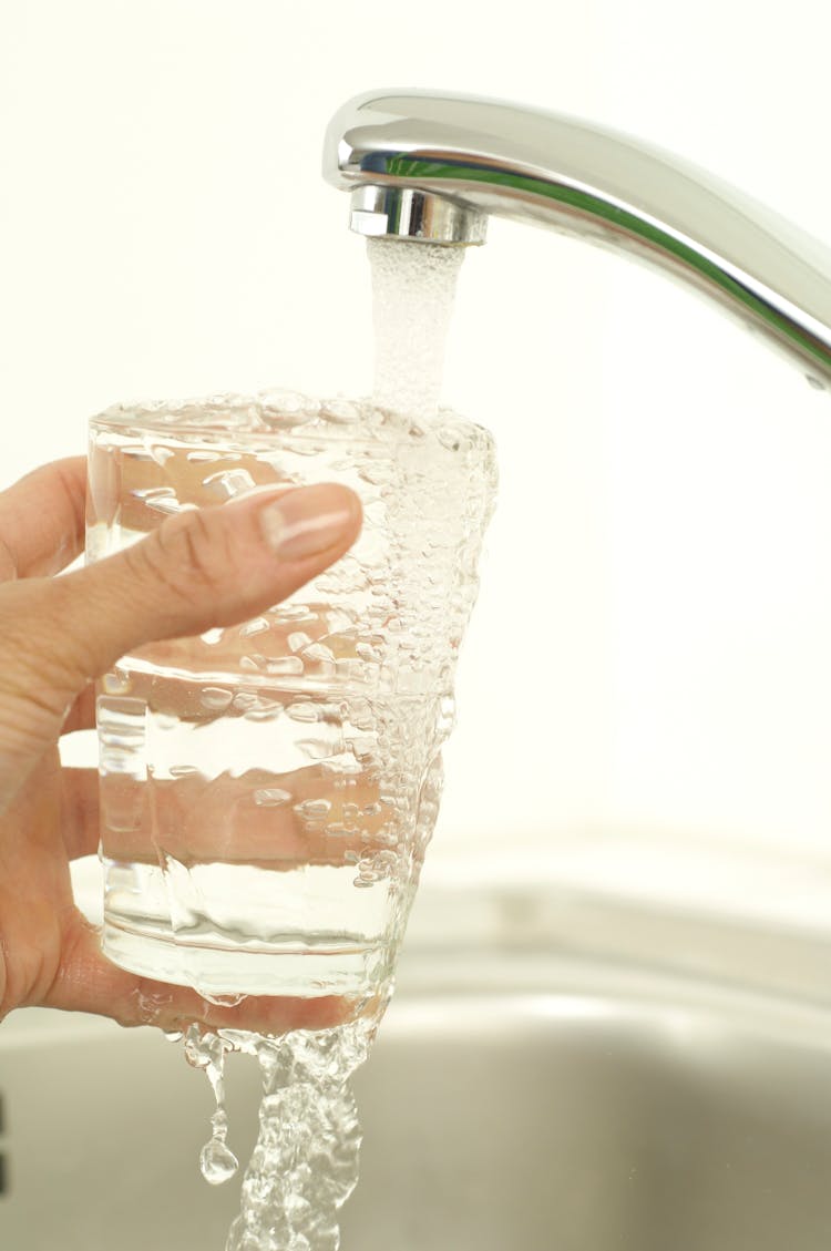 Hand Holding Glass Of Tap Water