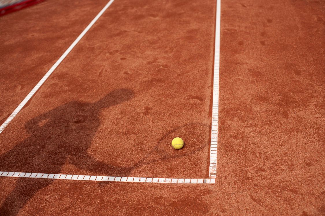Tennis-court A pristine tennis court with clear markings and a net, ready for play