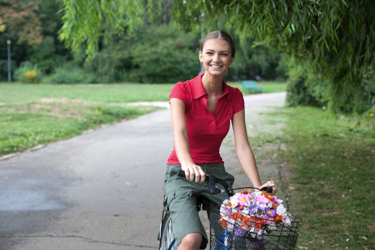 Young Smiling Woman Riding On A Bicycle 