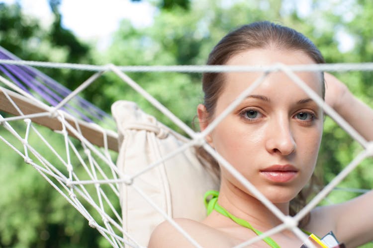 Woman Lying In Hammock In Garden