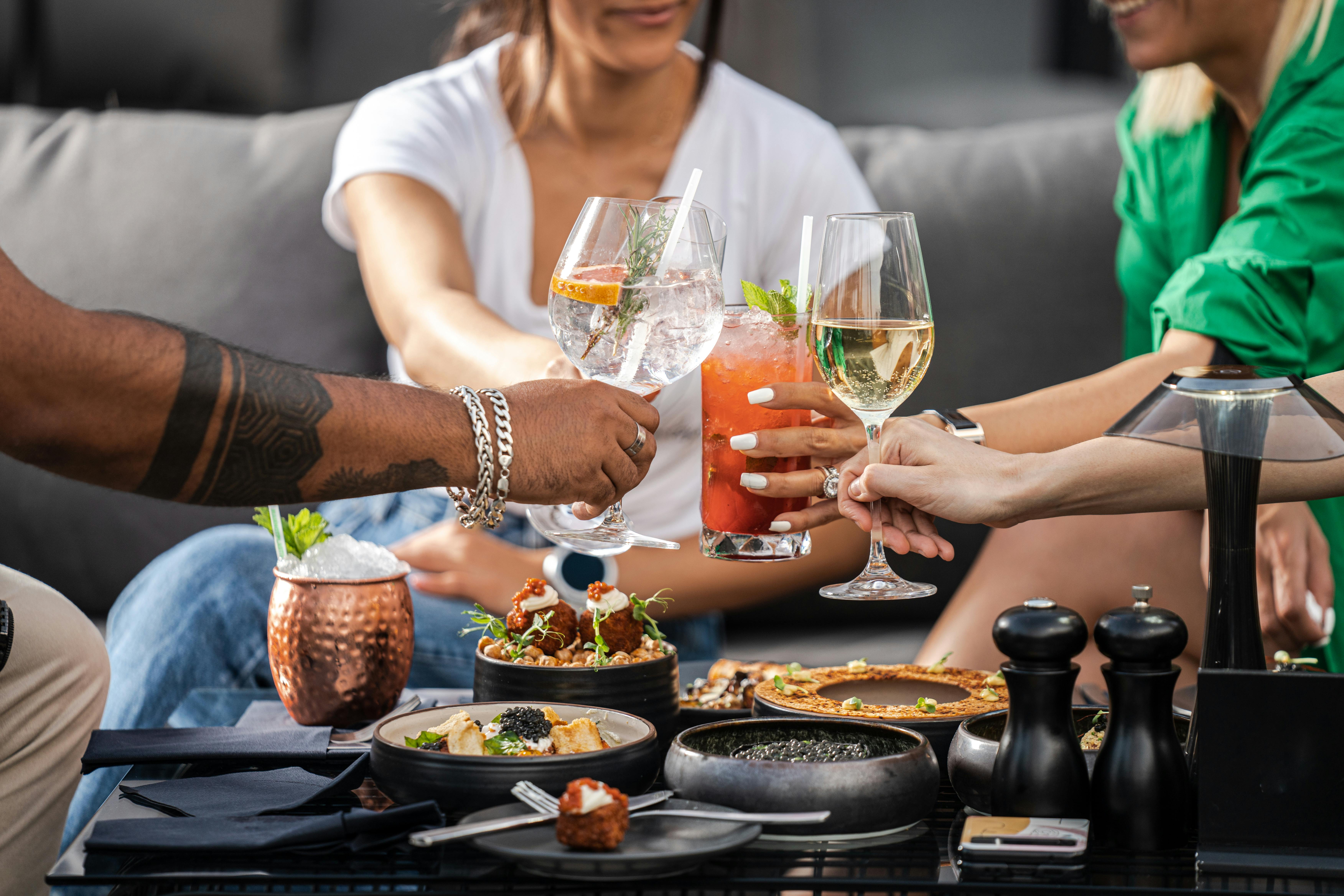 friends drinking cocktails on a terrace