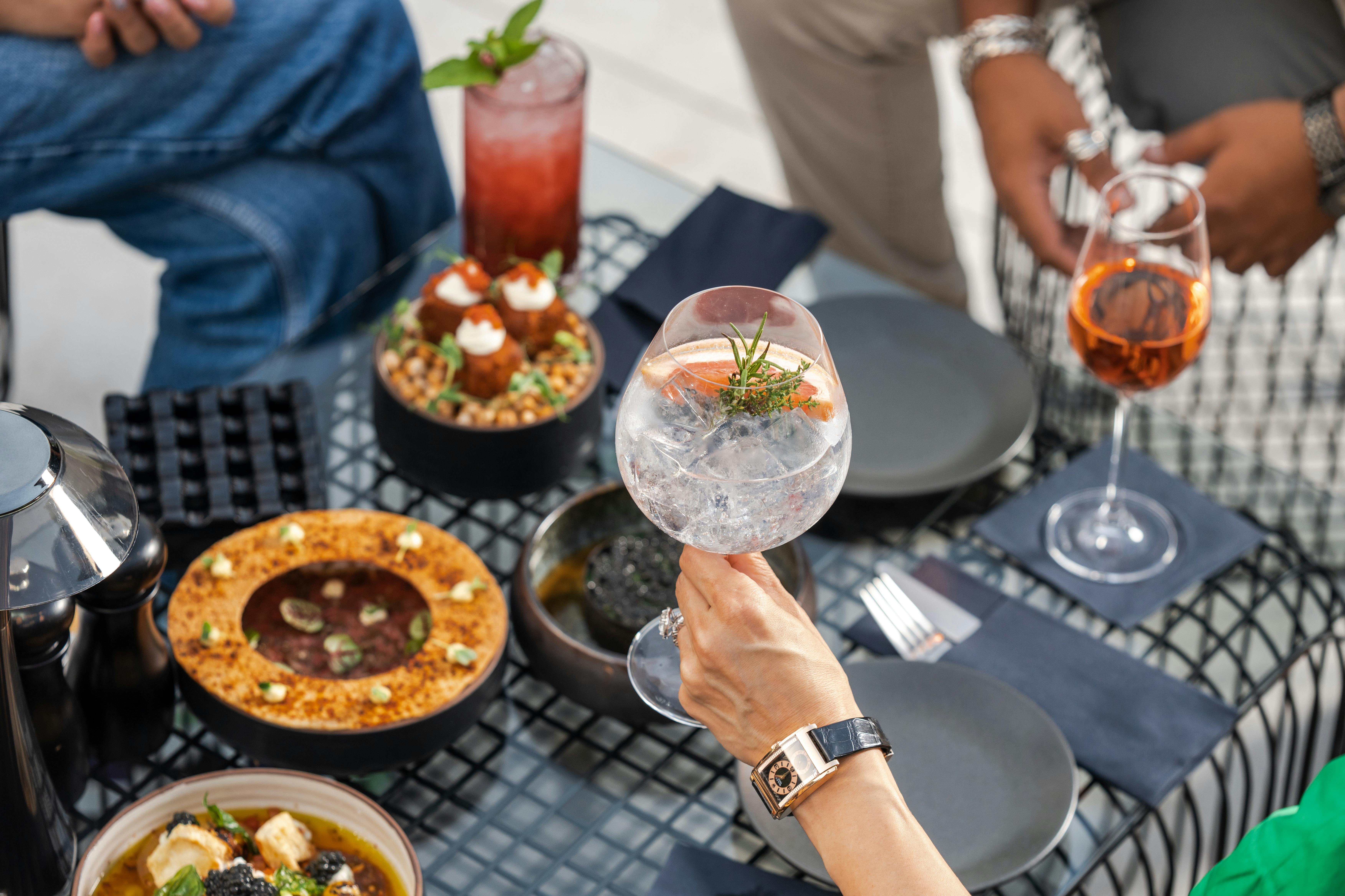 Gourmet small plates and craft mocktails artfully presented on a table in an upscale lounge setting - Luxury cannabis lounge