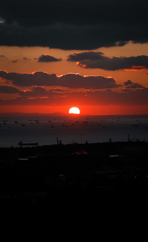 Free Stunning view of a sunset with a vivid sky and sea horizon, perfect for travel inspiration. Stock Photo