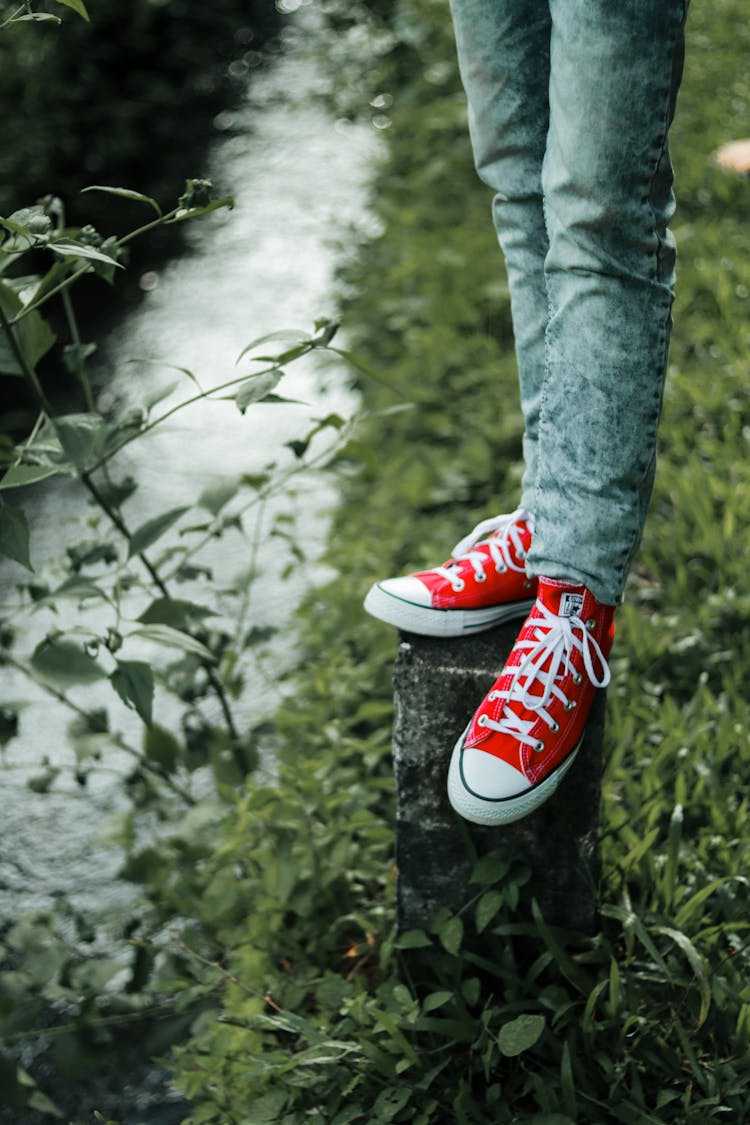 Man In Red Sneakers Standing On A Post 