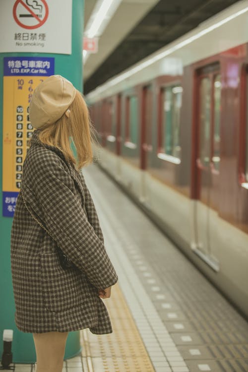 Woman in Checkered Blazer Waiting for the Train