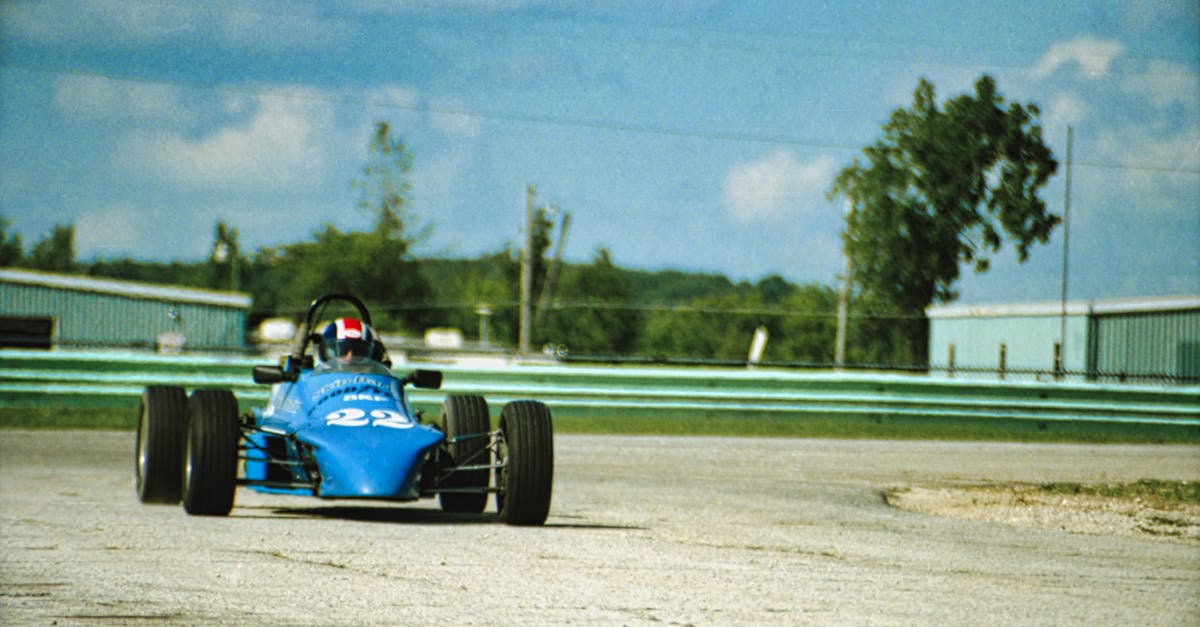 Blue Racecar Driving on the Track · Free Stock Photo
