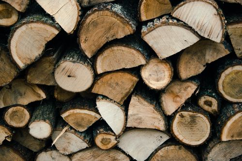 Free A close-up view of neatly stacked chopped firewood logs, perfect for rustic decor. Stock Photo
