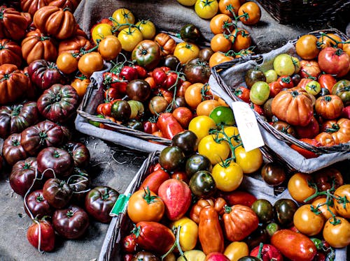 Assorted Colorful Fruits Displayed on Baskets and Gray Textile