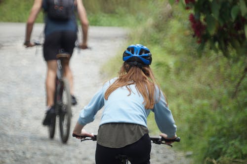 Woman Riding a Bike on Dirt Road