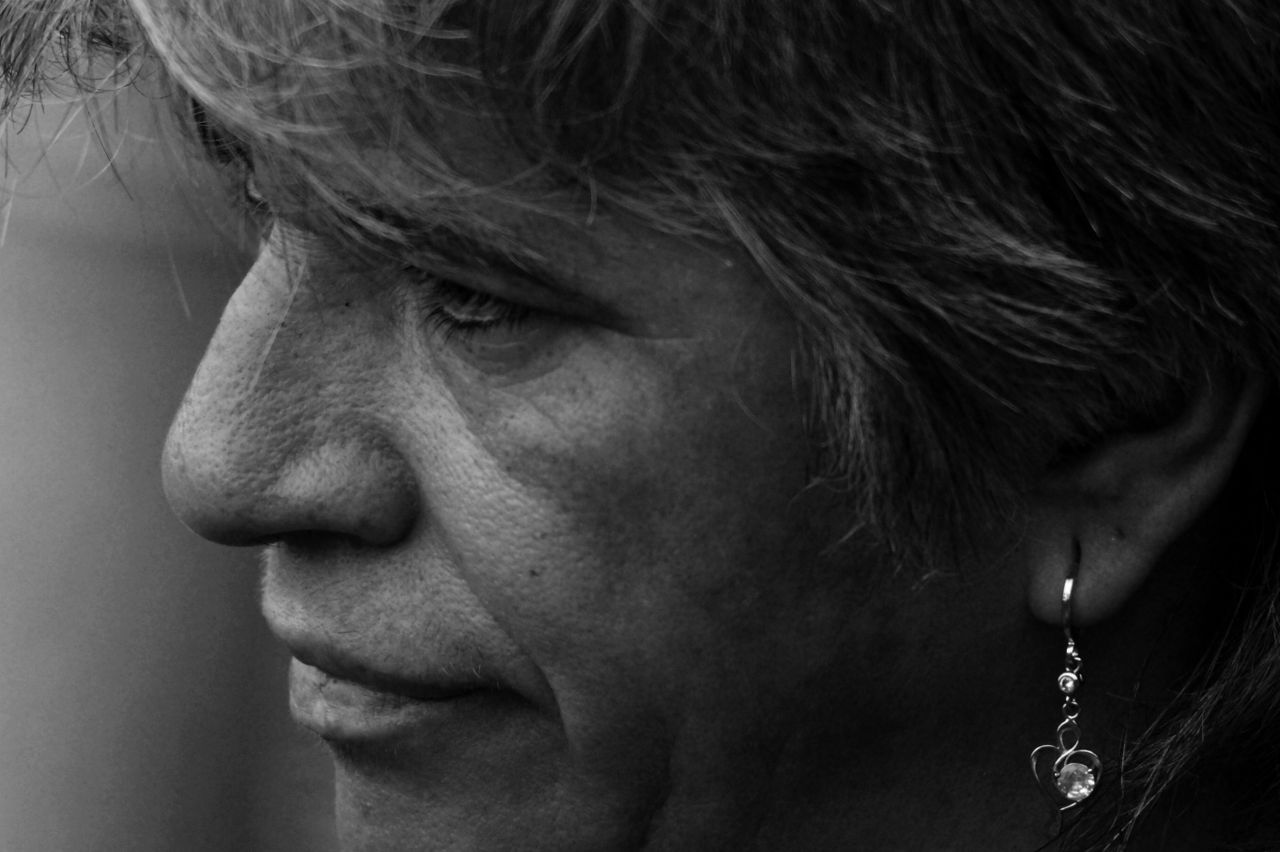artistic side profile portrait of an adult wearing a dangling earring
