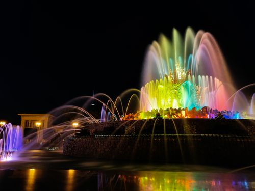 Free Colorful illuminated fountain with vibrant lights creating a stunning night display. Stock Photo
