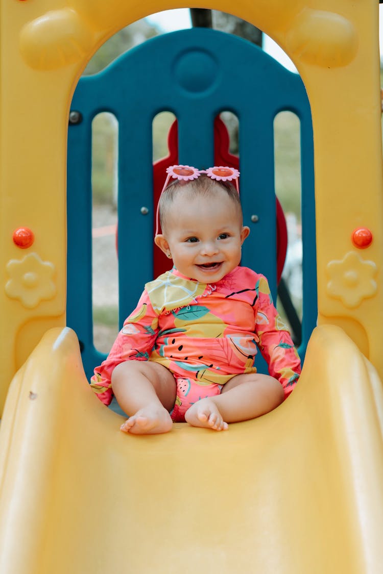 A Cute Baby On A Slide