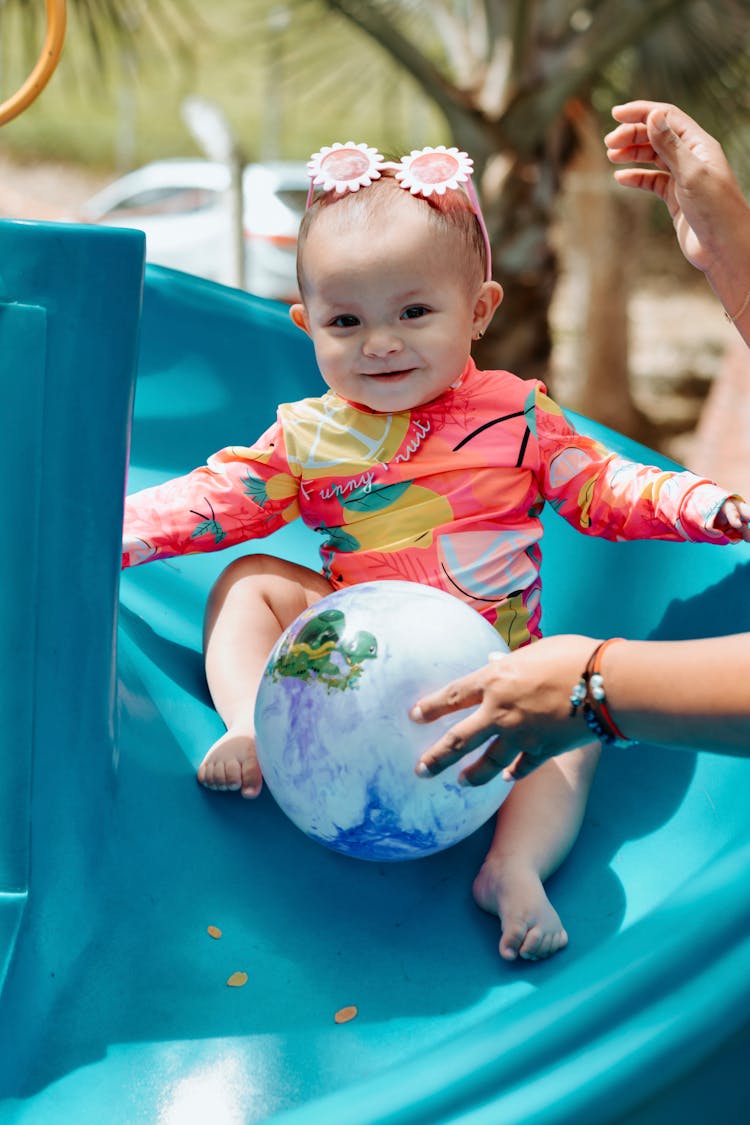 A Cute Baby On A Slide