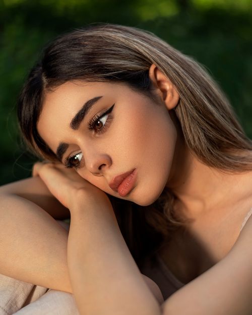 Free Stunning portrait of a woman in natural light with a thoughtful expression. Stock Photo