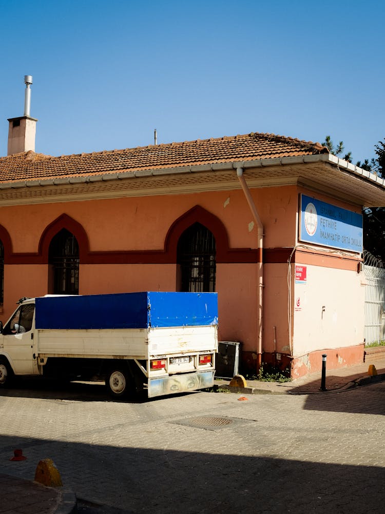 A Truck Parked Beside A Building